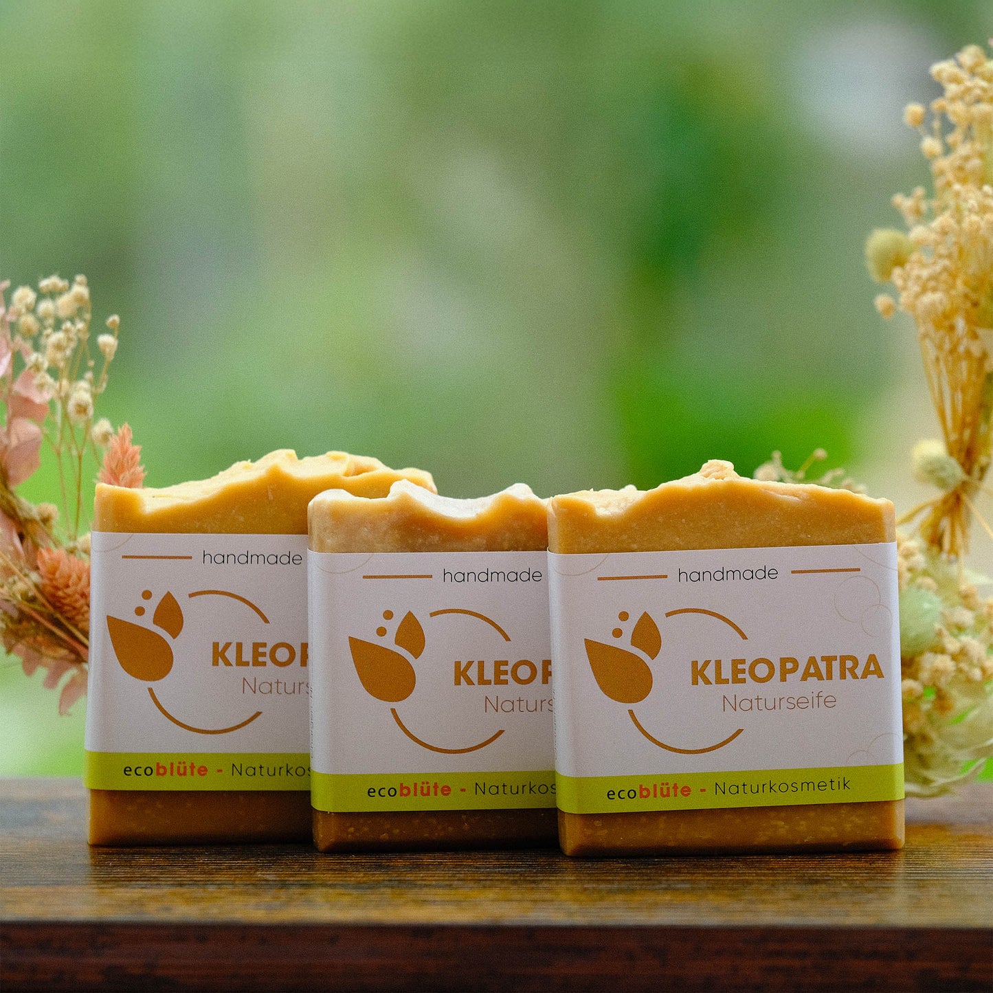 Naturseife Kleopatra mit Banderole, handgemacht in unserer Seifenmanufaktur, eine sehr feine Gesichtsseife mit Mandelblütenduft, 3er Set mit Gesteck